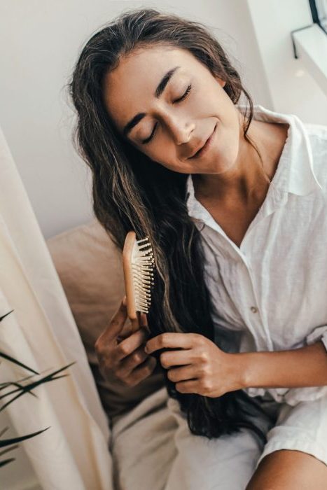 young woman brushing her long beautiful hair sit 2021 09 24 18 36 59 utc 3 scaled e1642944389792